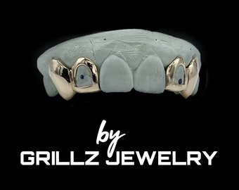 Trendy custom grillz with open face and middle two skipped with small fangs / canines added, done fast, express delivered by Grillz jewelry