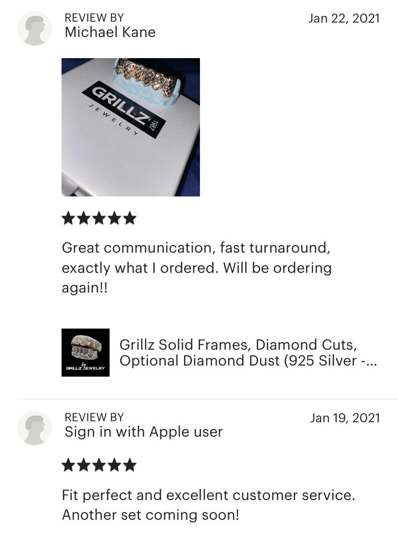 Puede incluir: Primer plano de una parrilla de oro con detalles de diamantes. La parrilla se muestra en una caja blanca con el texto "Grillz Jewelry" impreso en ella.