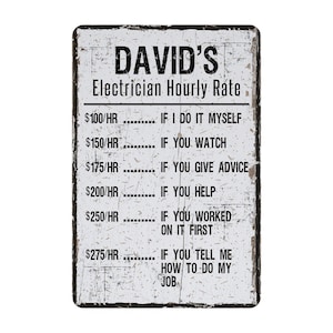 May include: A white sign with black text that reads "DAVID'S Electrician Hourly Rate". The sign lists different hourly rates for an electrician based on the level of help provided.  The rates range from $100/HR to $275/HR.