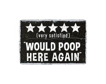 May include: A rectangular black sign with white text and five white stars. The text reads "(very satisfied)" above the phrase "WOULD POOP HERE AGAIN."