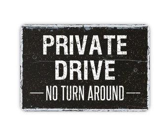May include: Black and white sign with the text "PRIVATE DRIVE - NO TURN AROUND -" on a weathered wood background.
