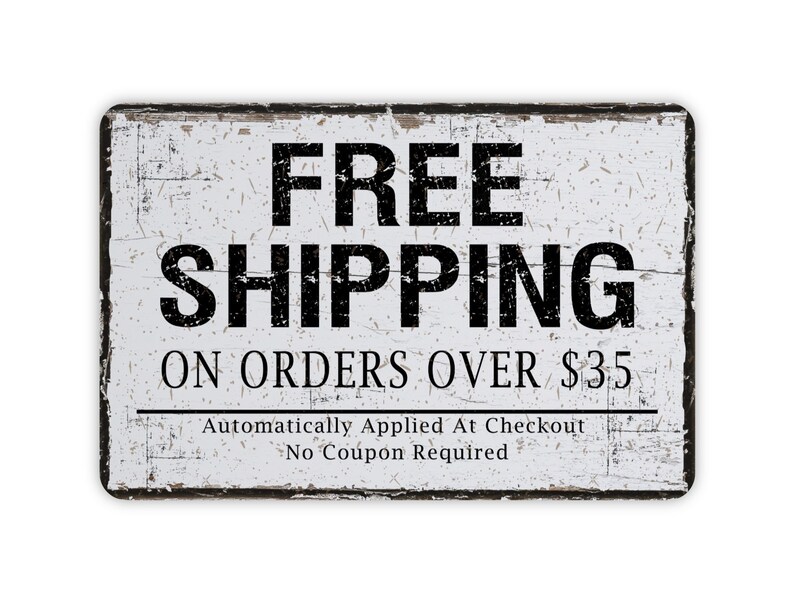 May include: A rectangular, distressed white sign with black text. The words "FREE SHIPPING" are prominently displayed at the top, followed by "ON ORDERS OVER $35". Additional text below reads "Automatically Applied At Checkout No Coupon Required".