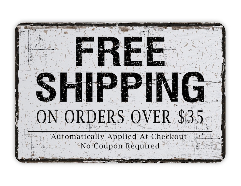 May include: A rectangular, distressed white sign with black text that reads "FREE SHIPPING" and "ON ORDERS OVER $35." The sign has a black border and additional text at the bottom. The sign has a vintage, rustic aesthetic.