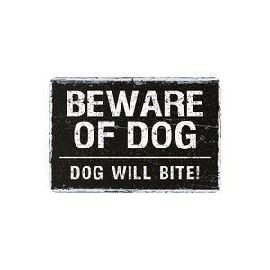 May include: A rectangular black sign with white text that reads "BEWARE OF DOG" above "DOG WILL BITE!" The sign has a distressed, weathered appearance, suggesting it is made of wood or metal.