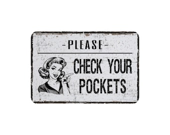 May include: A rectangular, distressed white sign with black text that reads "PLEASE CHECK YOUR POCKETS." A vintage illustration of a woman pointing to the right is on the left side of the sign. The sign has a black border.