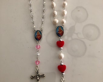 The sacred heart of Mary car rosaries