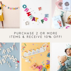 May include: A collection of felt letter banners, including "Happy Birthday", "Oh What Fun", and "Merry Christmas". There are also felt crowns, a felt gingerbread man, and a felt Christmas bucket list card. The text "Purchase 2 or more items & receive 10% off!" is displayed in the center of the image.