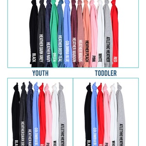 May include: A color chart showing different t-shirt colors available for adults, youth, and toddlers. The colors include black, dark grey, navy, green, teal, Columbia blue, maroon, mauve, peach, pink, white, and red.