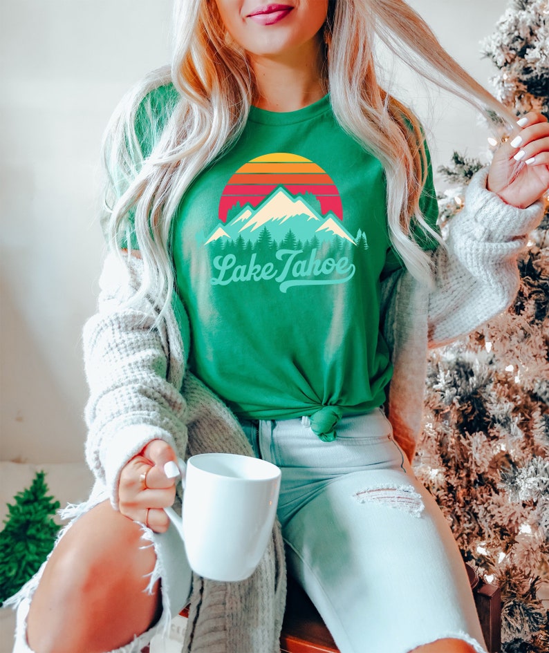 May include: A green t-shirt with a retro sunset graphic and the text "Lake Tahoe" in a vintage font.