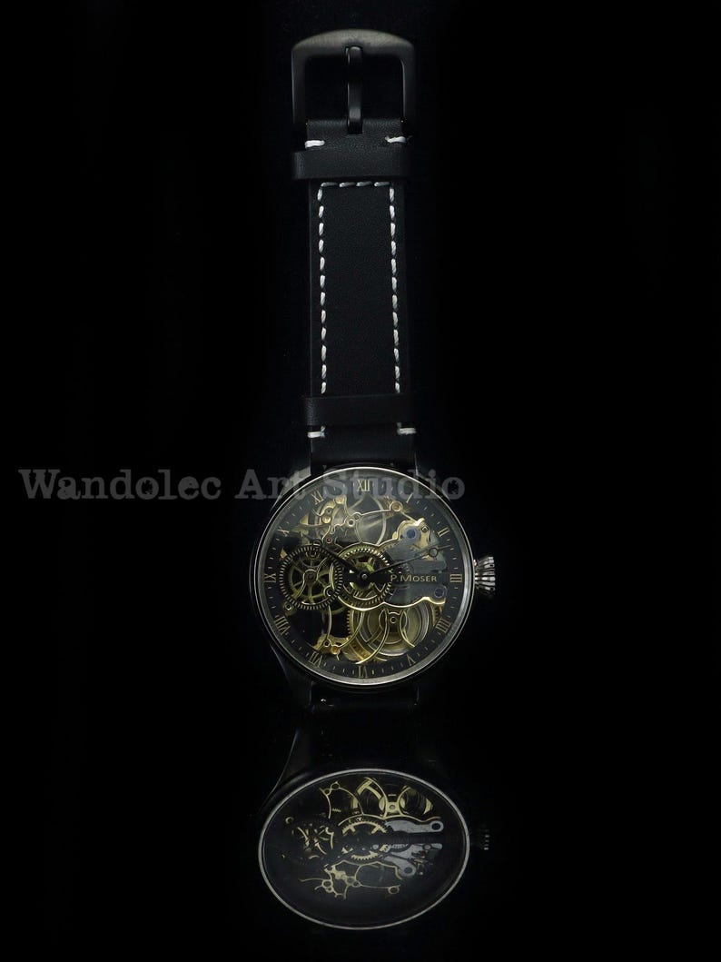 May include: A black wristwatch with a skeleton dial, showcasing the intricate inner workings. The watch has a black leather strap with white stitching. The watch face displays Roman numerals and the brand name "H. Moser". The watch is reflected in a dark surface.