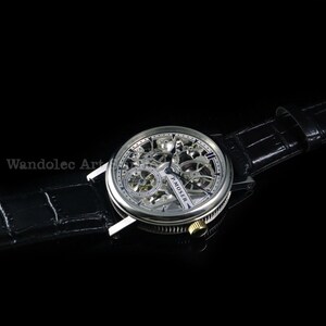 May include: A silver skeleton watch with a black leather band. The watch face reveals the intricate inner workings of the timepiece. The watch has a round face with a silver bezel and a black leather strap. The watch is a luxury item.