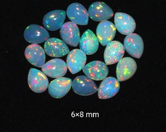 May include: A collection of 18 pear-shaped opals, each measuring 6x8 mm. The opals are a pale blue-green color with iridescent flashes of color.
