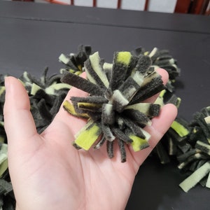 black and yellow 2.5 inch fleece pom poms for crafting for crochet for knitting