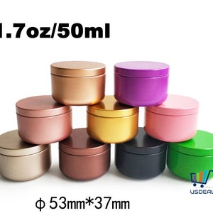 May include: A collection of round, metal containers in various colors, including gold, pink, purple, and green. Each container has a matching lid. The text "1.7oz/50ml" and "Φ 53mm*37mm" are visible.