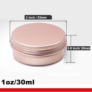 May include: A rose gold metal tin with a screw-on lid. The tin is 2 inches in diameter and 0.8 inches tall. It has a capacity of 1 ounce or 30 milliliters.