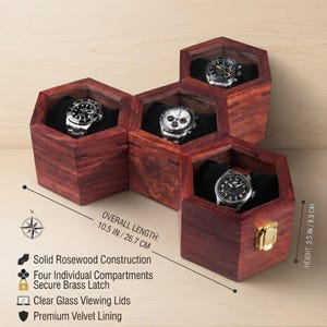 May include: A hexagonal rosewood watch box with four individual compartments, clear glass lids, and a brass latch. The box measures 10.5 inches in length and 3.5 inches in height. Each compartment contains a watch resting on black velvet lining.