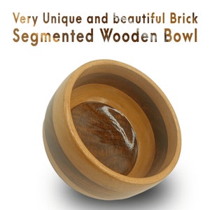 May include: A segmented wooden bowl with a dark brown wood center and light brown wood bands around the rim. The bowl is made of multiple pieces of wood that have been joined together to create a unique and beautiful design.