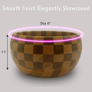 May include: A wooden bowl with a checkered pattern. The bowl is 6 inches in diameter and 3.5 inches tall.  Dia 6"