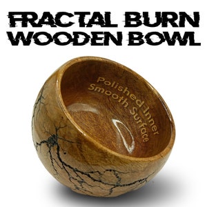 May include: A wooden bowl with a fractal burn design. The inside of the bowl is polished smooth. The bowl is made of wood and has a natural brown color.