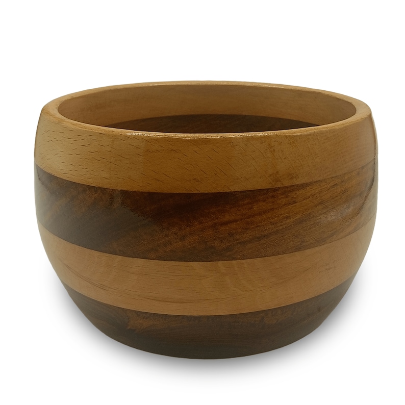 May include: A wooden bowl with a striped pattern in shades of brown and light wood. The bowl is round and has a smooth, polished finish.