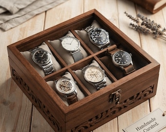May include: A square wooden watch box with a glass lid and a metal latch, featuring intricate carved side panels. The interior contains six compartments, each holding a wristwatch on a soft cushion. A tag reads Handmade & Curated.