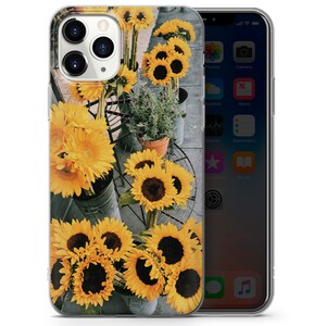 May include: A clear phone case with a design of yellow sunflowers on a gray background.