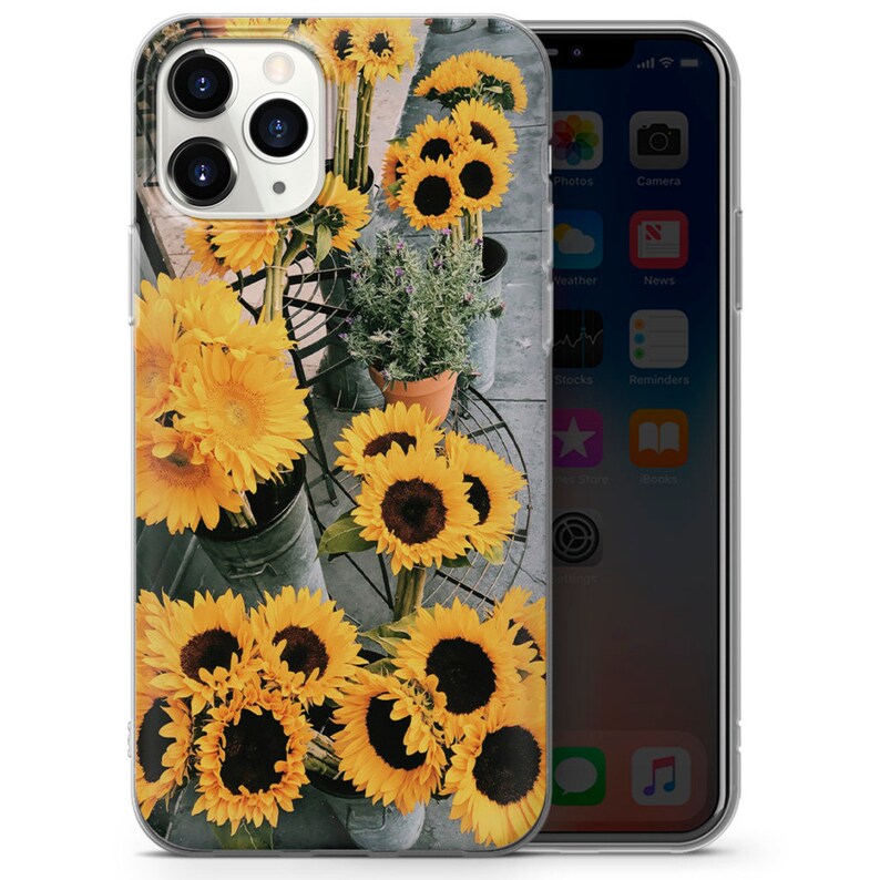 May include: A clear phone case with a design of yellow sunflowers on a gray background.