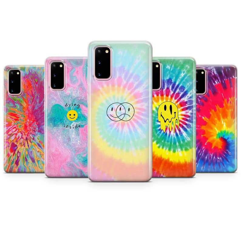May include: Five different phone cases with tie-dye patterns. The cases feature various smiley face designs, including a melting smiley face, a smiley face with a frown, and two connected smiley faces. The cases are all made of clear plastic and have a tie-dye pattern in various colors, including pink, blue, yellow, orange, and green.