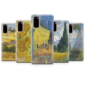 May include: Five different phone cases featuring famous Vincent van Gogh paintings. The cases are clear and show the paintings through the plastic. The paintings include a cafe at night, sunflowers, a field with a farmhouse, a cypress tree, and a woman with an umbrella.
