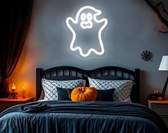 May include: A white neon ghost sign is mounted on a gray wall above a bed with dark blue bedding. A small orange pumpkin sits on the bed. The room is decorated for Halloween. The text "By ZPL Neon Custom" is at the bottom.