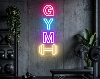 May include: A vertical neon sign featuring the word GYM stacked in bright colors, with the letter G in pink, Y in blue, and M in purple, followed by a yellow dumbbell icon at the bottom, all mounted on a clear backing against a dark wall.