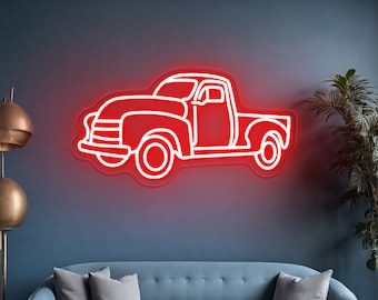 Könnte beinhalten: Ein rotes Neonzeichen in Form eines Oldtimer-Pickups ist an einer dunkelblauen Wand angebracht. Der Umriss des Trucks leuchtet hell und erzeugt einen auffälligen Kontrast. Das Schild befindet sich über einem blauen Sofa mit grauen Kissen. Der Text "By ZP Neon Custom" steht unten.