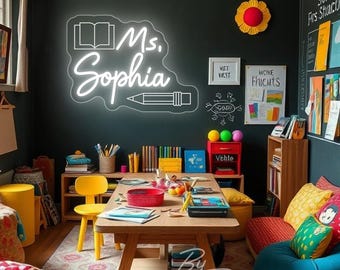 May include: A classroom scene with a neon sign that reads "Ms. Sophia" with a book and pencil design. The room features a wooden table, colorful pillows, and various educational materials. The walls are dark with artwork and a large sun decoration.