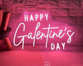 May include: A neon sign with the words "HAPPY Galentine's DAY" in white script. The sign is illuminated with a bright pink glow, set against a textured brick wall. The sign is signed "By ZP ZP Neon Custom".