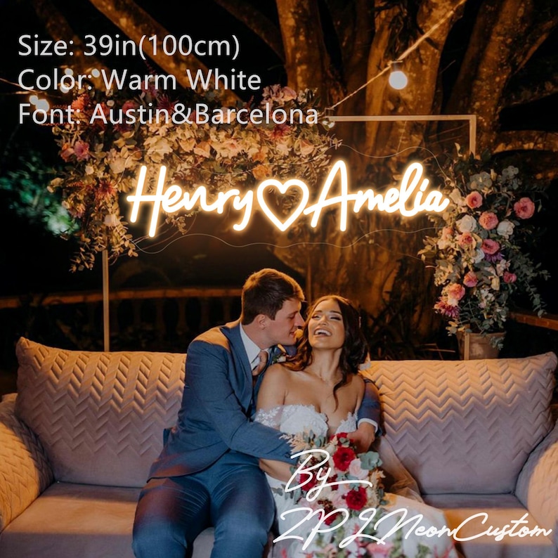 May include: A custom neon sign displaying the names Henry and Amelia with a heart symbol in the center. The sign emits a warm white light, measures 39 inches in width, and uses the Austin and Barcelona font styles for the lettering.
