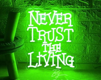 May include: Green neon sign with white lettering that reads "Never Trust The Living" by 2P2 Neon Custom.