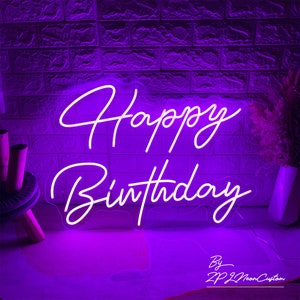 May include: A neon sign in a purple hue displays the words "Happy Birthday" in a cursive font. The sign is mounted on a brick-patterned wall. The text "By ZP Z Neon Custom" is at the bottom.