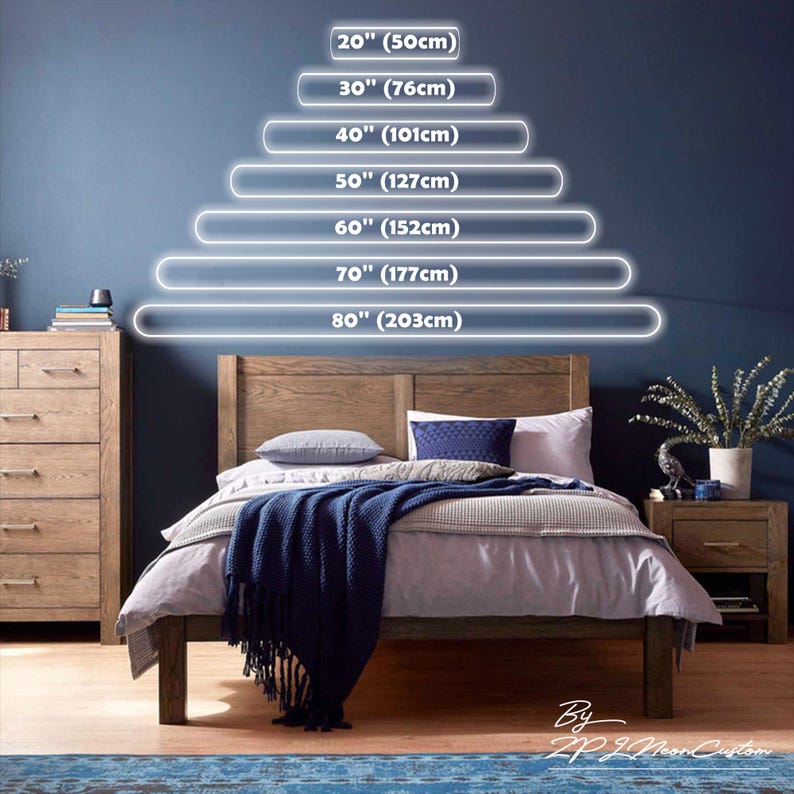 May include: A wooden bed frame with a headboard, dressed with bedding and a navy blue throw blanket. Above the bed, illuminated lines indicate bed sizes from 20 inches (50cm) to 80 inches (203cm). A wooden dresser and nightstand are on either side.