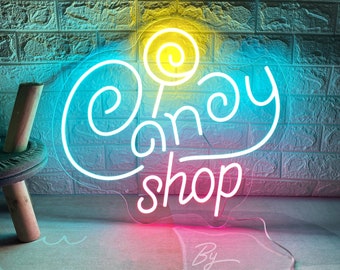 May include: A neon sign with a pink, blue, and yellow gradient. The sign says "Candy Shop" with a stylized lollipop graphic. The sign is lit up and has a white outline.