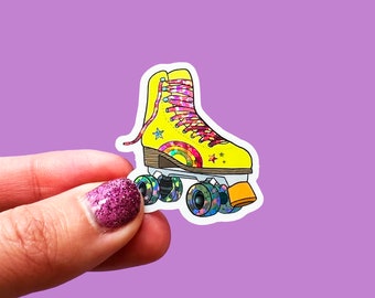 May include: Yellow roller skate with rainbow and star details. The wheels are black with a rainbow pattern. The skate is on a white background.
