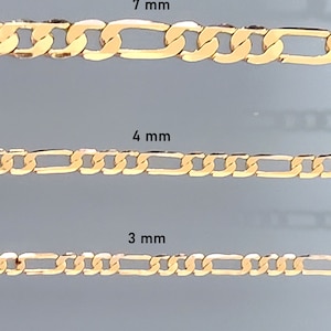 May include: Three gold Figaro chains in different sizes: 7 mm, 4 mm, and 3 mm. The chains are shown against a light gray background.
