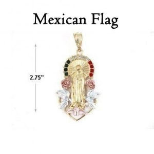 May include: Gold pendant featuring a depiction of the Virgin Mary with a halo and a red, white, and green halo representing the Mexican flag. The pendant is 2.75 inches tall and has a floral design.