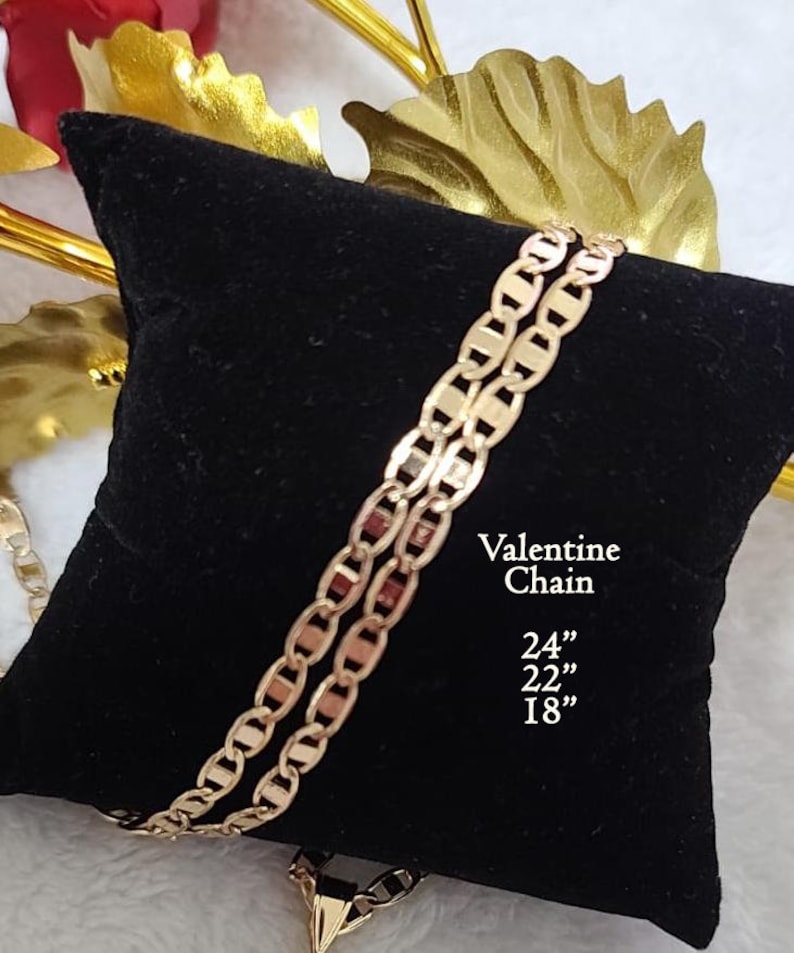 May include: Two gold Valentine chains on a black velvet cushion. The chains are 24", 22", and 18" long.