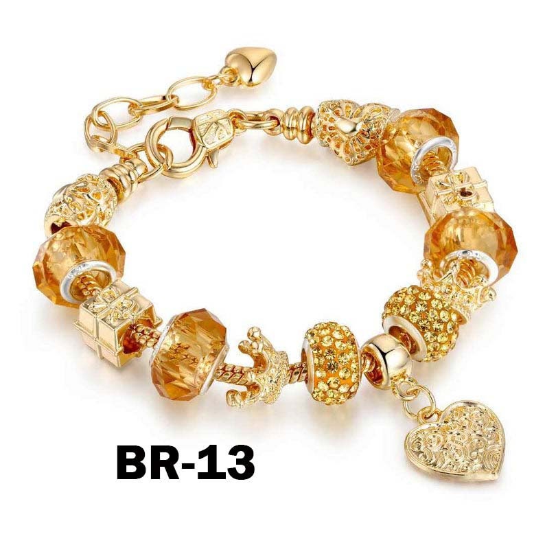 May include: Gold-toned charm bracelet with various decorative beads, including faceted amber-colored glass beads, a crown, and a heart charm. The bracelet has a lobster clasp closure and a heart-shaped charm. The text "BR-13" is printed on the bottom.