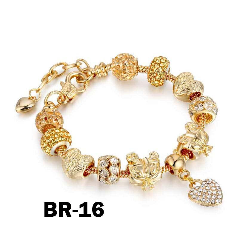 May include: Gold-toned charm bracelet with various decorative beads, including heart and round shapes, and a dangling heart charm. The bracelet features a lobster clasp closure and the text "BR-16".