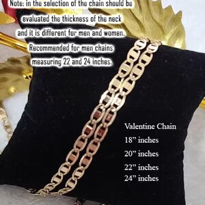 May include: A gold chain necklace with a lobster clasp. The chain is on a black velvet background. The text "Valentine Chain" is printed on the background, along with the sizes 18 inches, 20 inches, 22 inches, and 24 inches.
