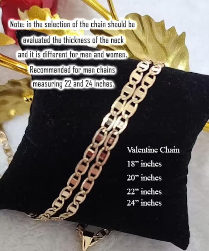 May include: A gold chain necklace with a lobster clasp. The chain is on a black velvet background. The text "Valentine Chain" is printed on the background, along with the sizes 18 inches, 20 inches, 22 inches, and 24 inches.