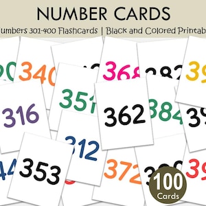 May include: A set of flashcards displaying numbers from 301 to 400, printed in various colours on white cards. The cards are scattered, with numbers in green, orange, purple, and black. The text "NUMBER CARDS" is at the top.