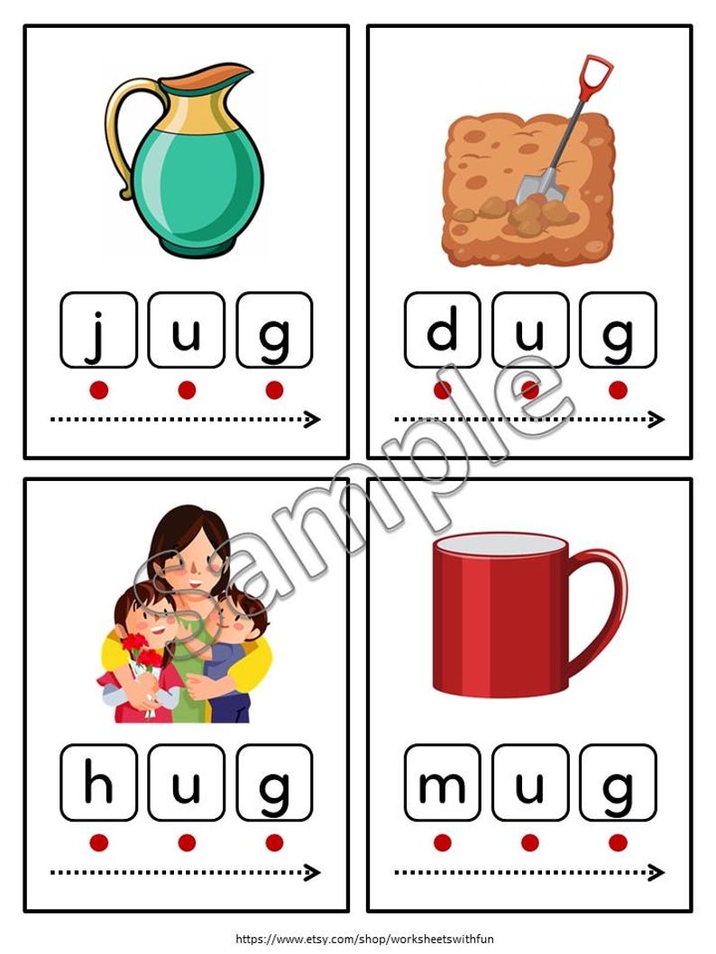 May include: Four flashcards for early literacy. The cards feature illustrations of a jug, a shovel digging in the dirt, a mother hugging two children, and a red mug. Each card has the corresponding word spelled out with letter blocks.