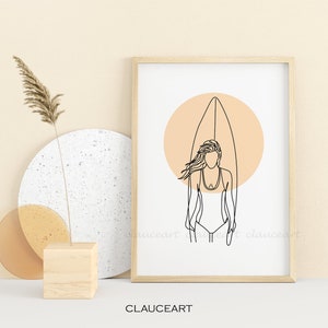 Pu&ograve; includere: Stampa di arte lineare di una donna in piedi su una tavola da surf con un cerchio color pesca dietro di lei. La stampa &egrave; in una cornice di legno e su uno sfondo bianco.